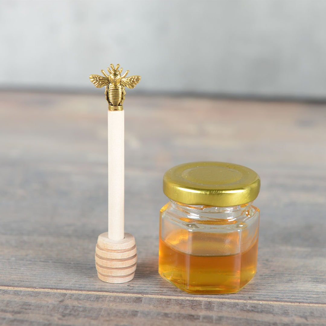 Cuillère à miel en bois avec abeille dorée